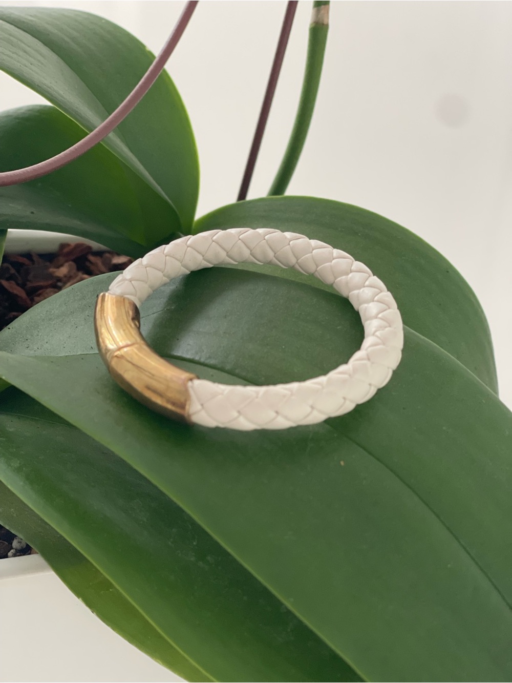 White Italian leather bracelet with gold plated clasp.